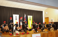 Several students on stage at Melba Copland Secondary School use the schools rowing machines.