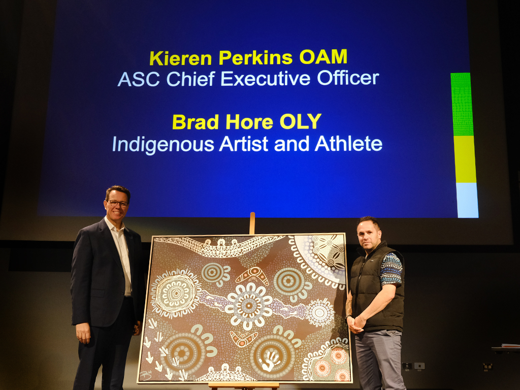 Kieren Perkins and Brad Hore stand either side of Hore's artwork.