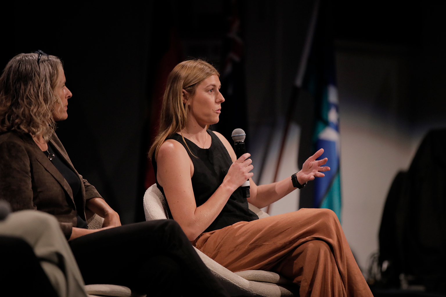 A woman speaks into a microphone