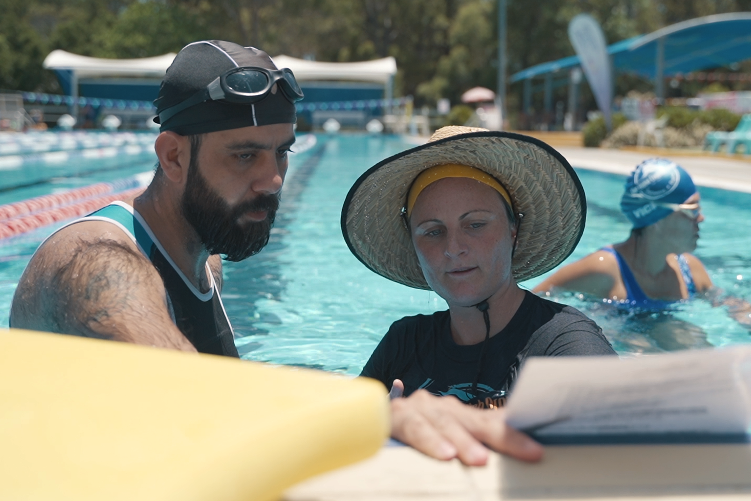 Aqua English Project Co-founder Sarah Scarce in the pool with one of the participants.