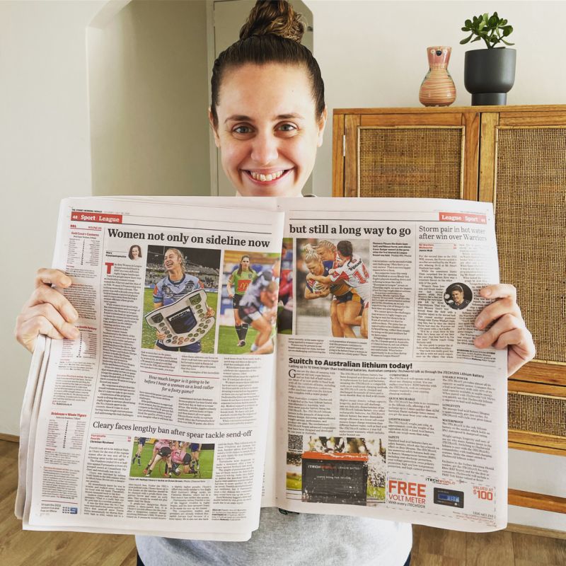 Mary Konstantopoulos holds up a newspaper
