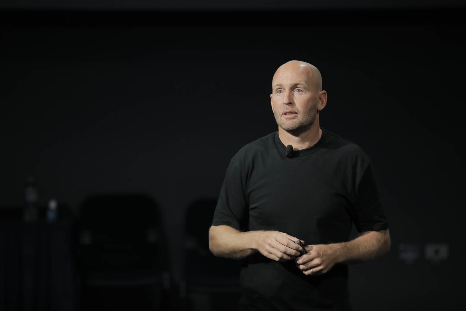 A man in black T-shirt talking
