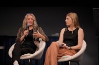 Two women sitting on stage