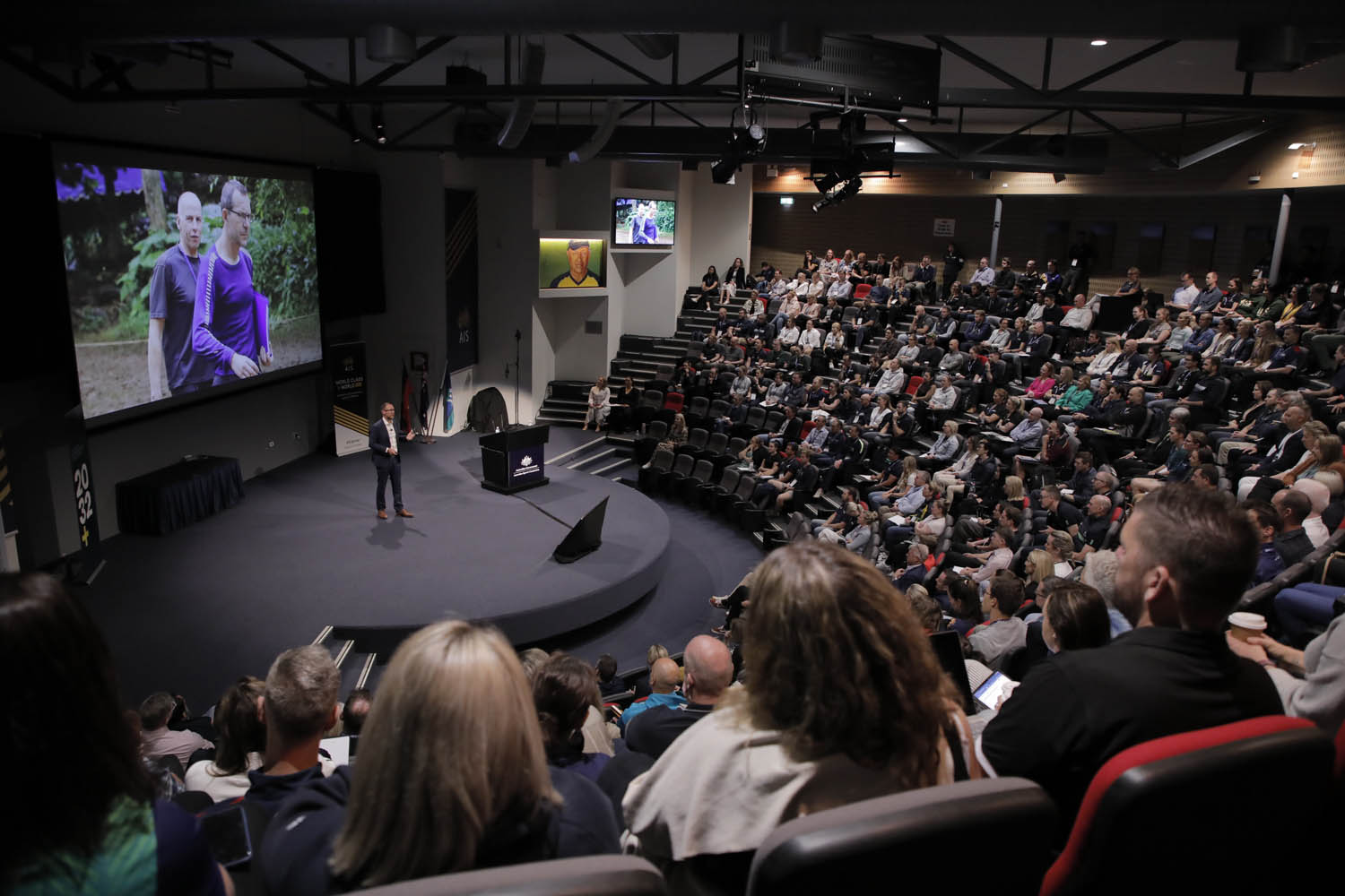 view of an auditorium with a man on stage