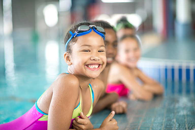 girl at the edge of a swimming pool