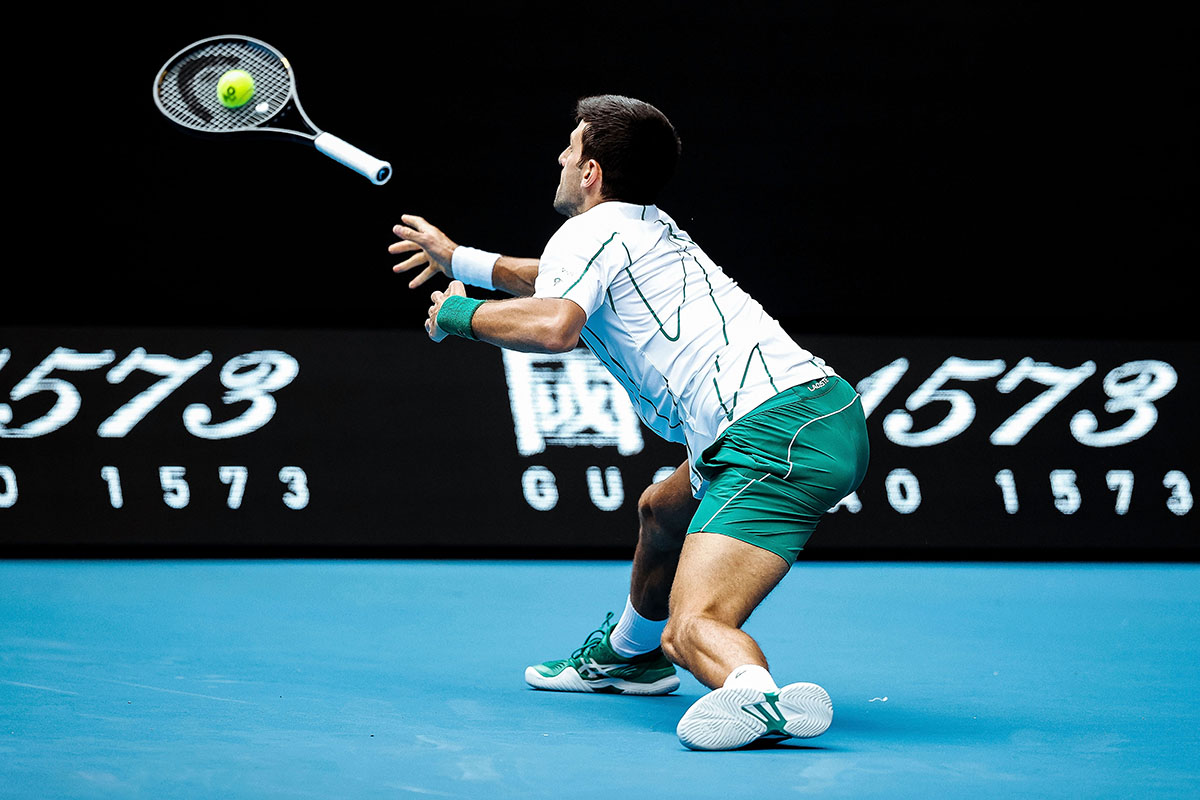 Serbia’s Novak Djokovic throws his racquet to attempt to return the ball © Darrian Traynor/Getty Images