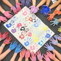 A painting of hands with hands with paint on them