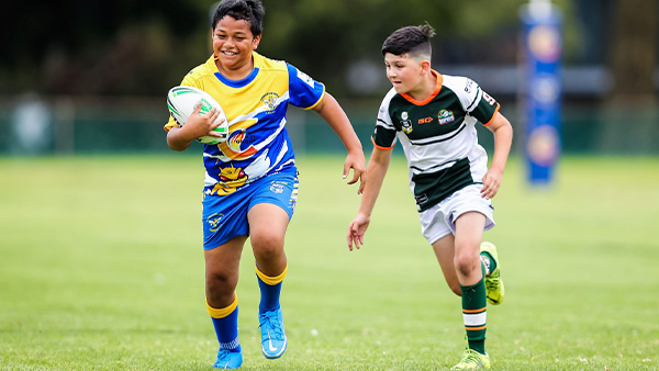Two junior kids playing rugby