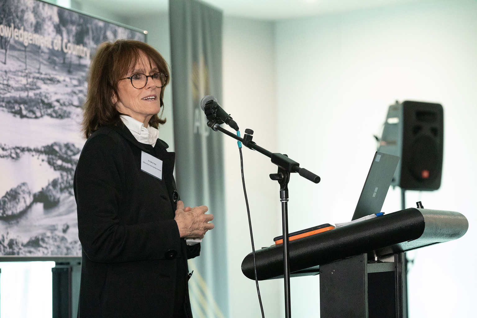 A woman standing behind a podium