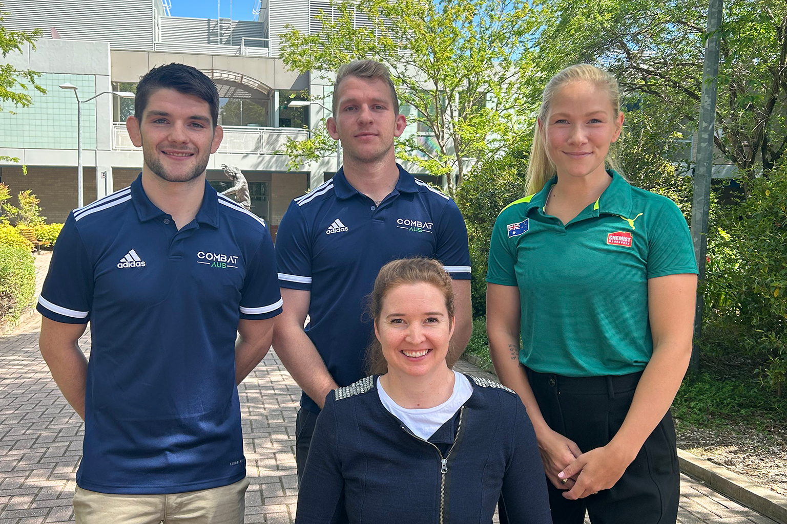 Four athletes gathered for a group photo