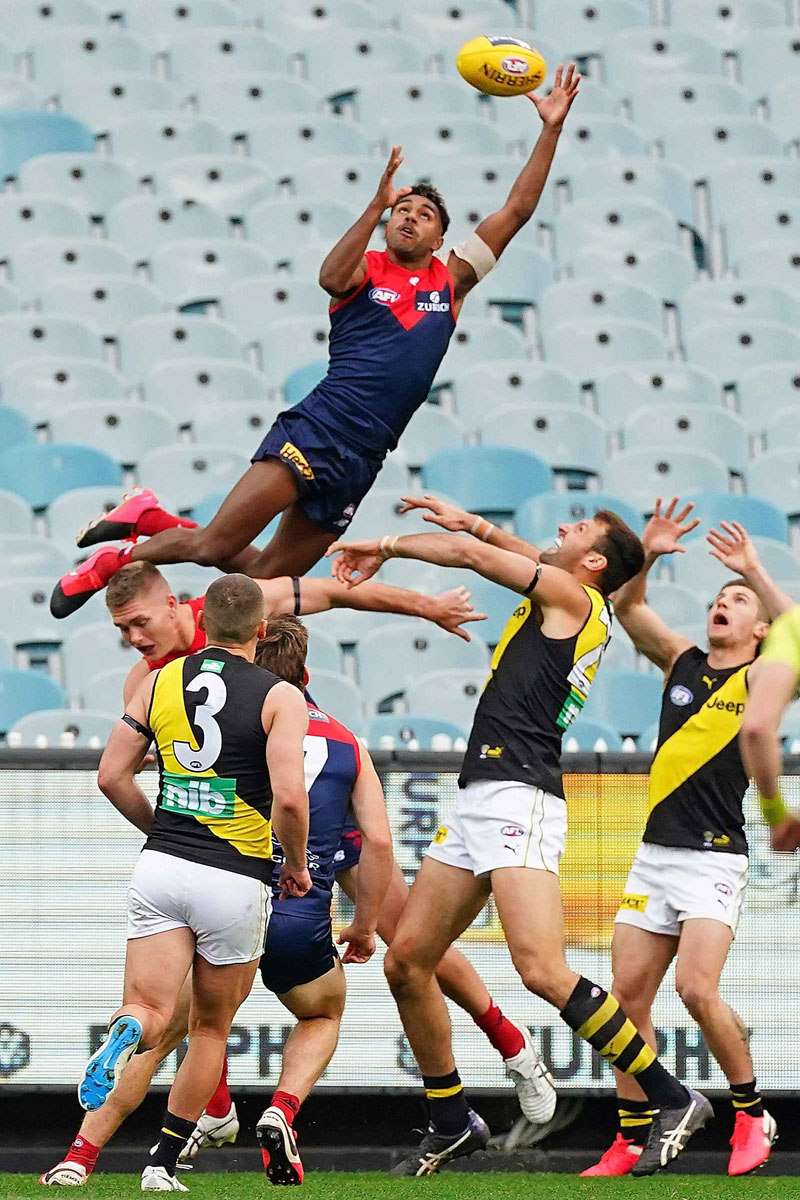 Kysaiah Pickett of the Melbourne Demons flies high for a spectacular mark © Scott Barbour/AAP