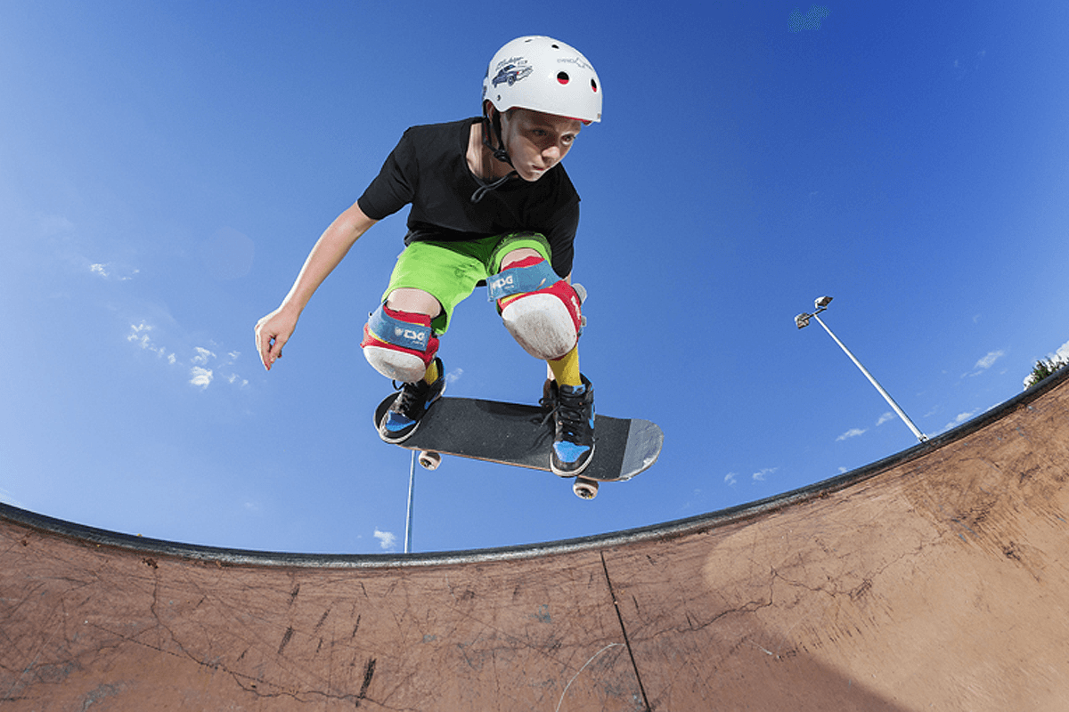 A young skateboarder in mid jump