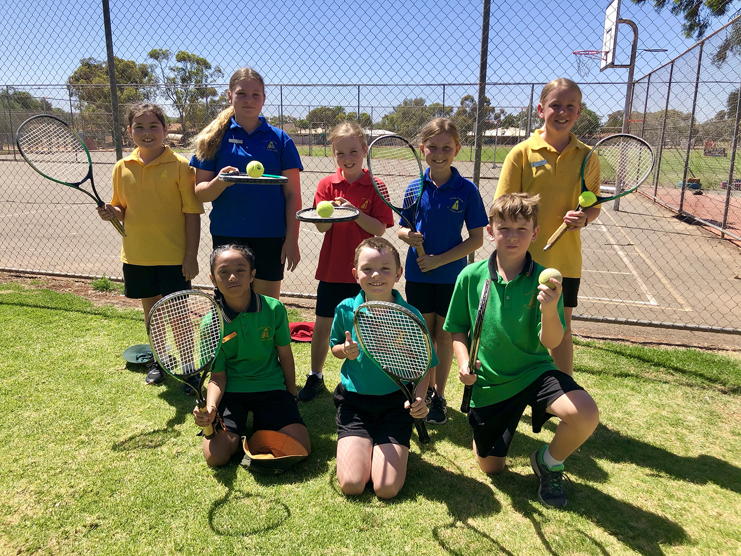 Students holding tennis racquet