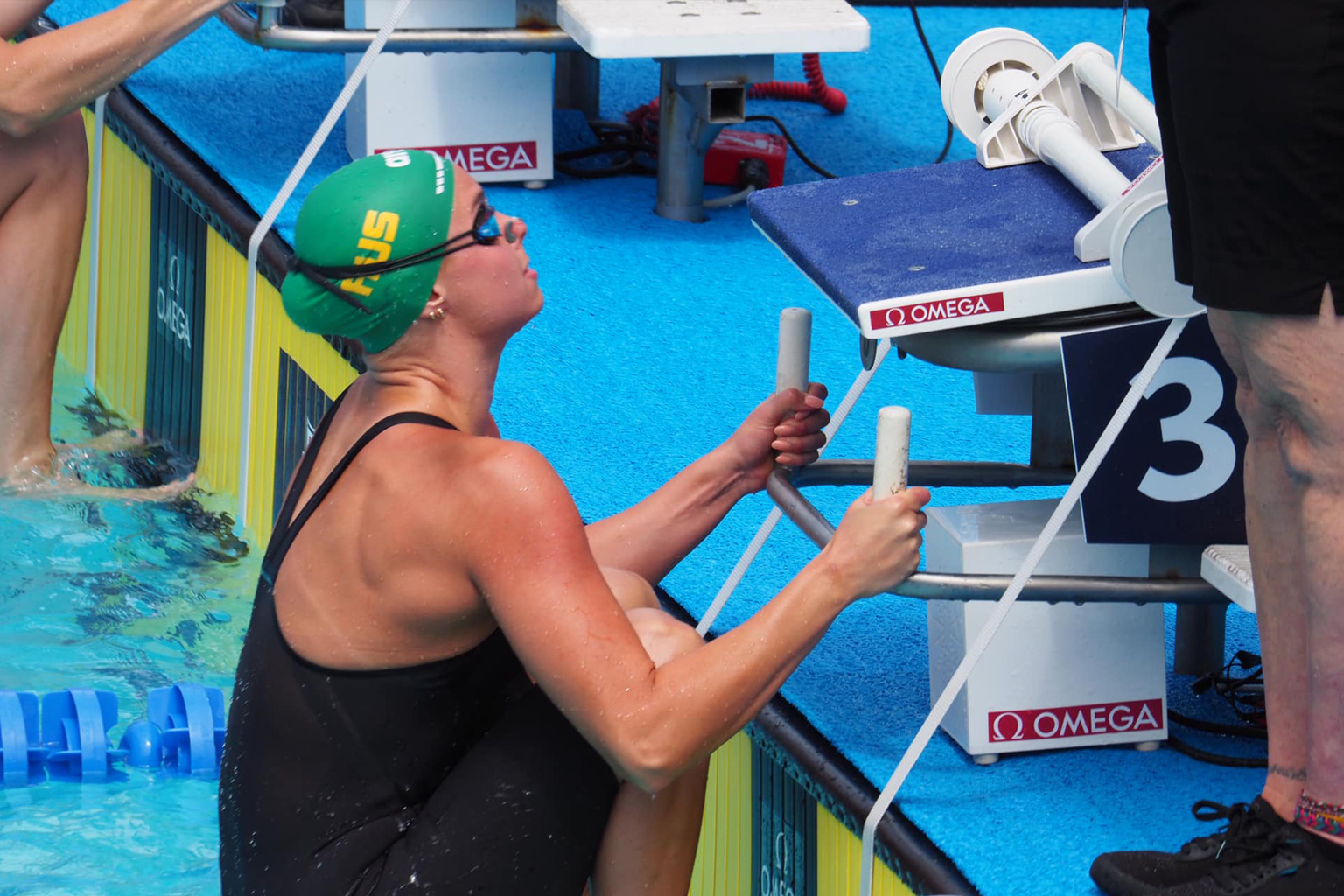 An australian swimmer prepares to start a backstroke swimming race
