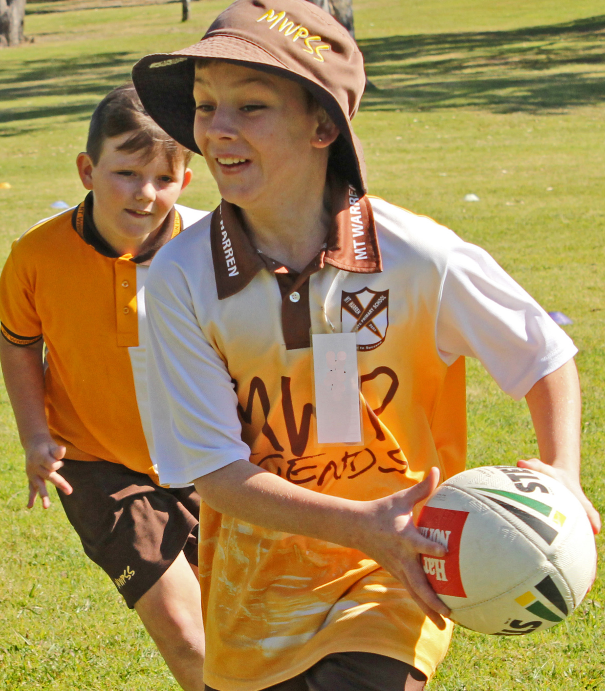 two children running with ball