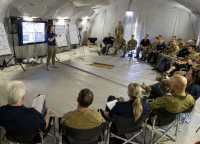 AIS representative Rosie Stanimirovic speaks with Australian Army personnel.