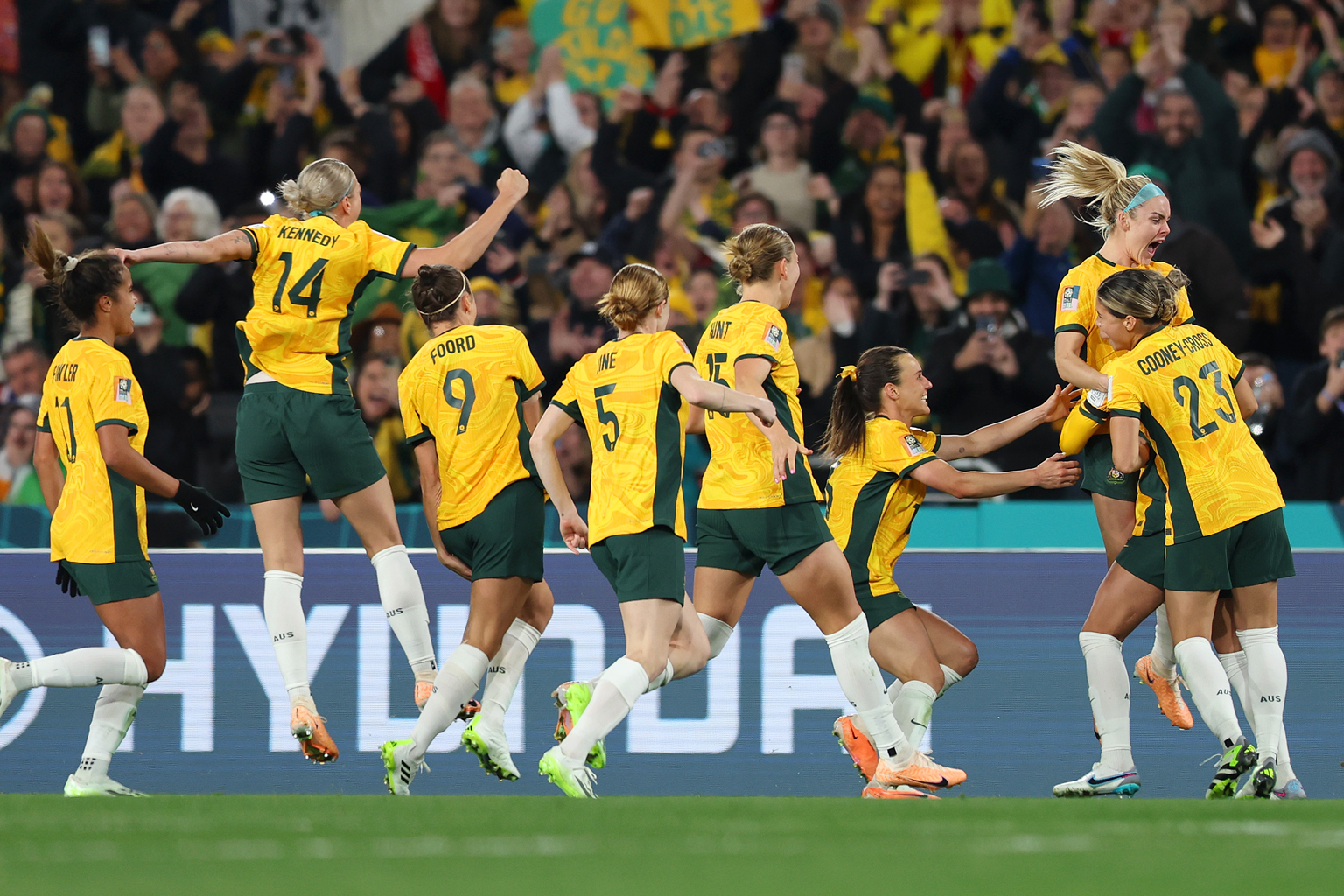 Australian womens soccer players celebrate on the field
