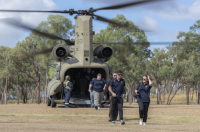 AIS representatives exit an Australian Army CH-47 Chinook en route from Townsville.