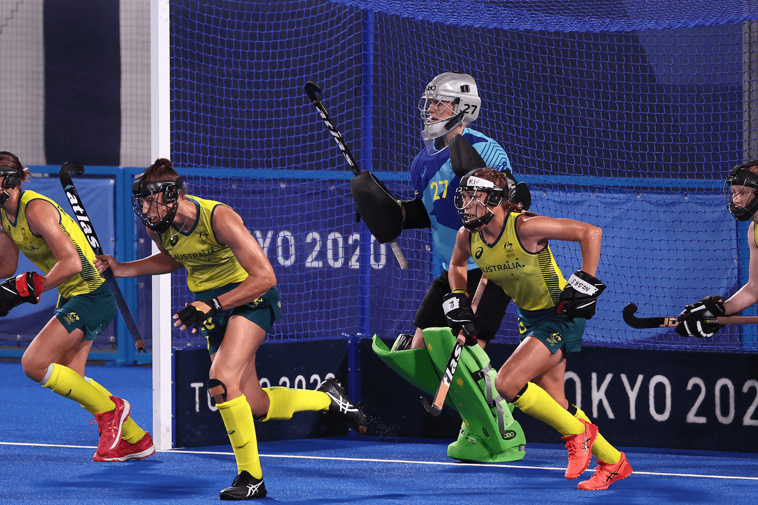 Members of the Hockeyroos Australian women's hockey team run out of goal, with keeper Rachael Lynch in blue protective clothing. Photo: Getty Images
