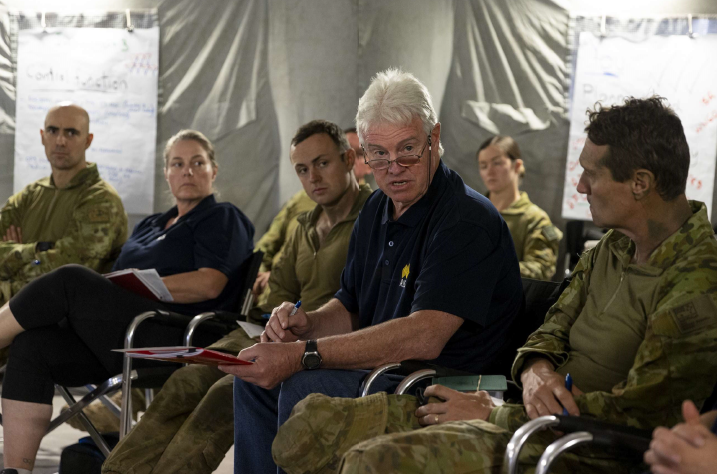 AIS' Peter Day speaks with Australian Army personnel and AIS representatives.