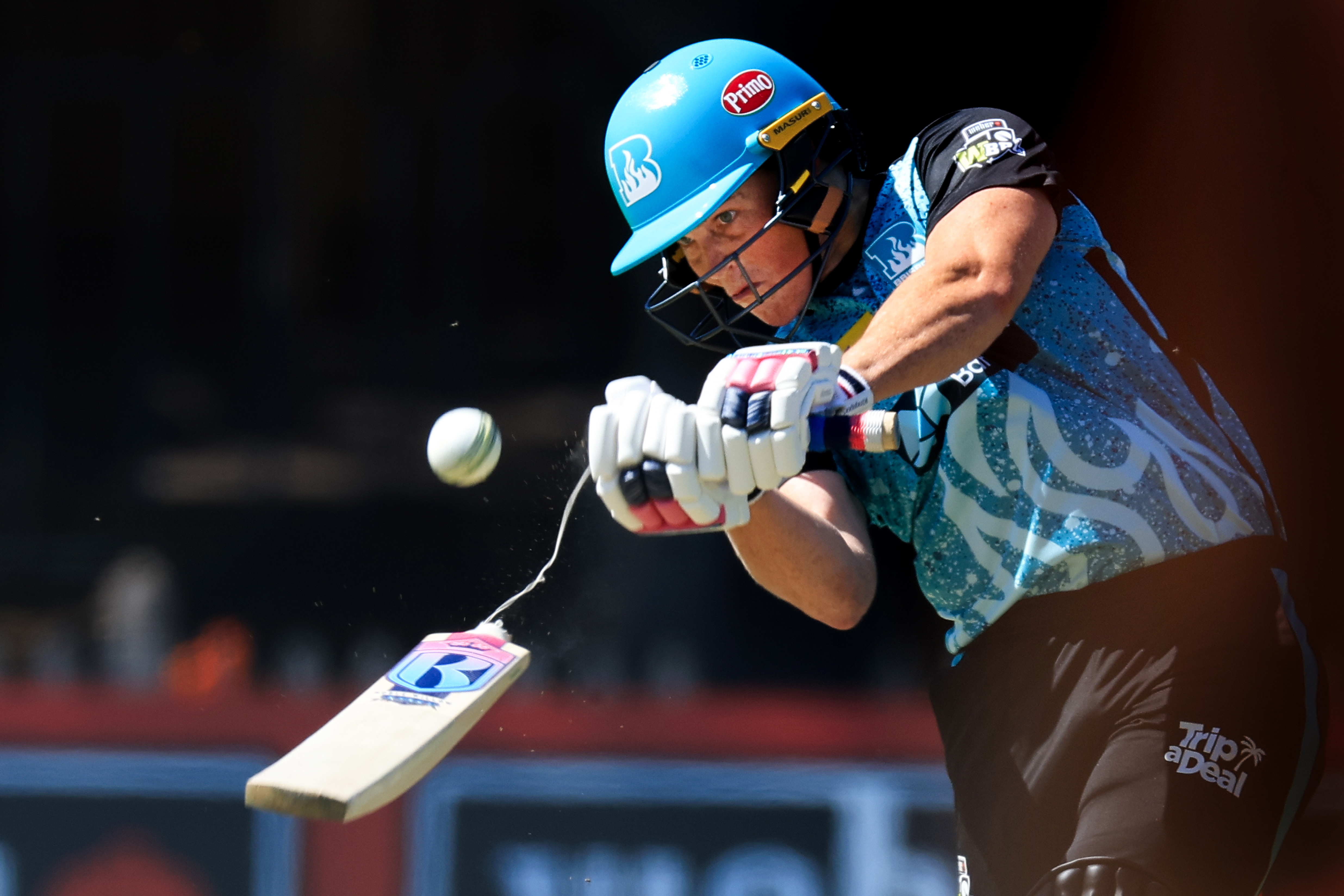 Image of Grace Harris from the Brisbane Heat breaking her bat as she hits a six in the WBBL game against the Perth Scorchers.