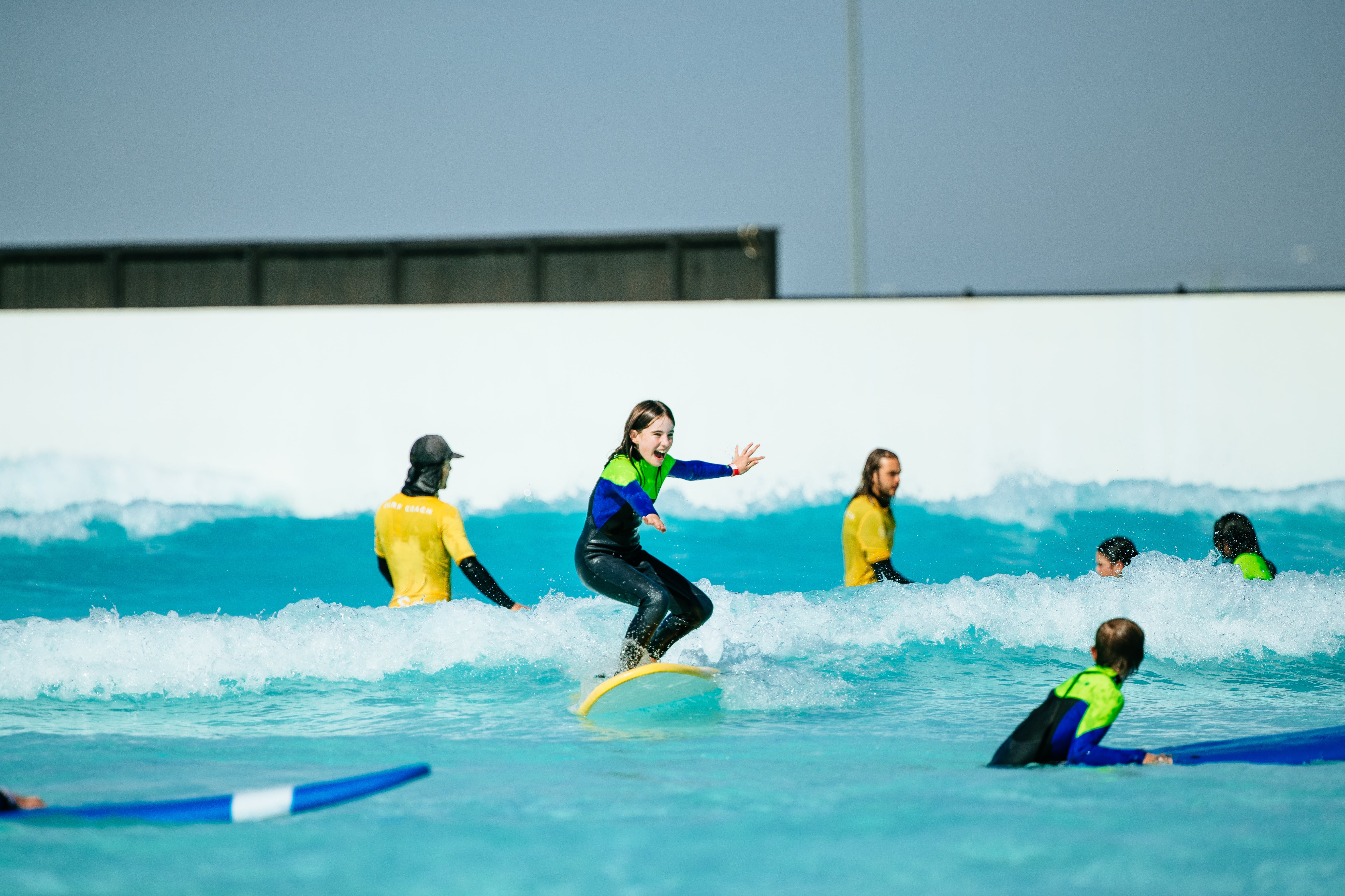 Students standing with surf boards