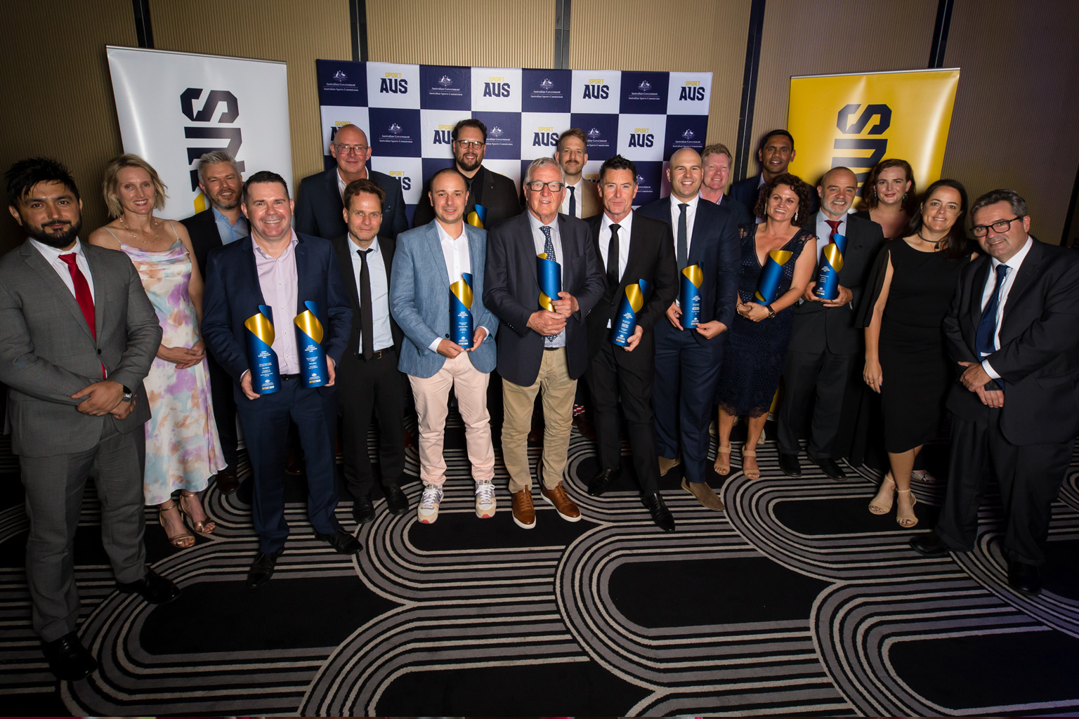 Winners from the 2021 Media Awards gathered with their trophies