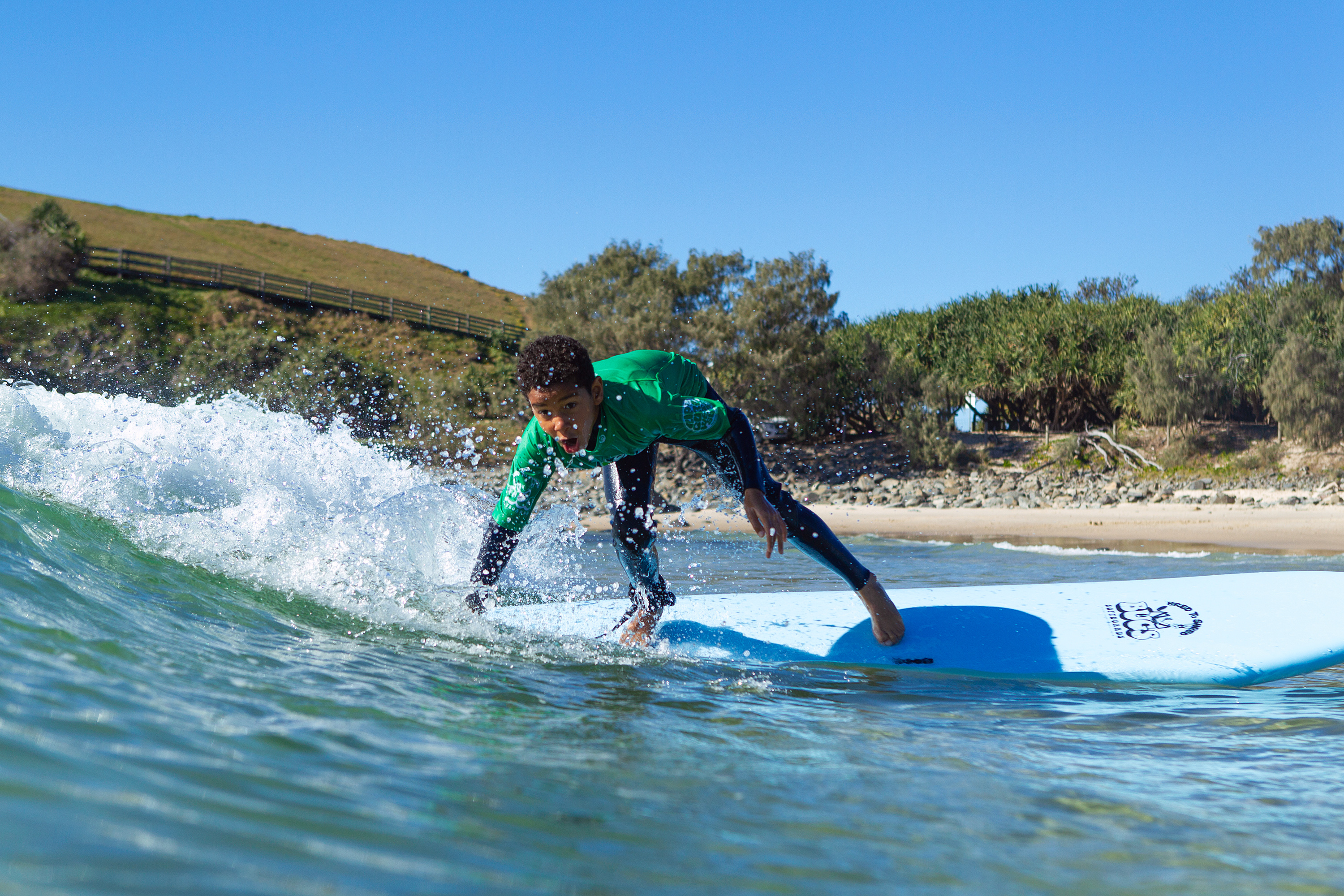 Teenager surfing a wave