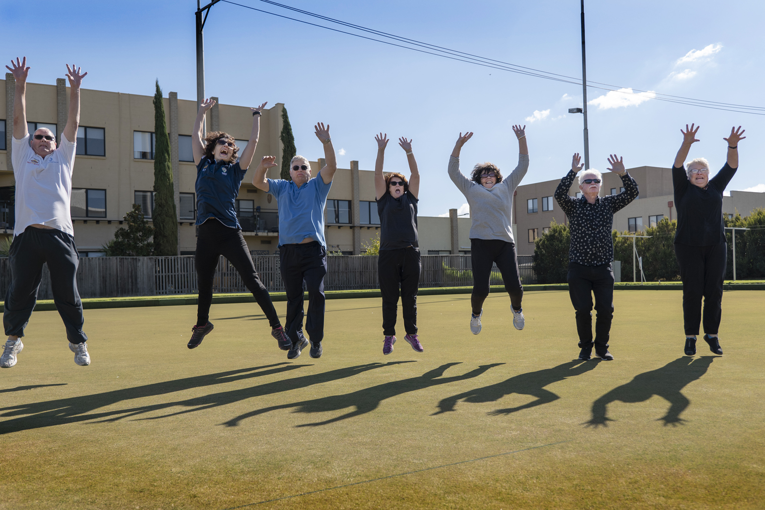 A group of people leap into the air in celebration