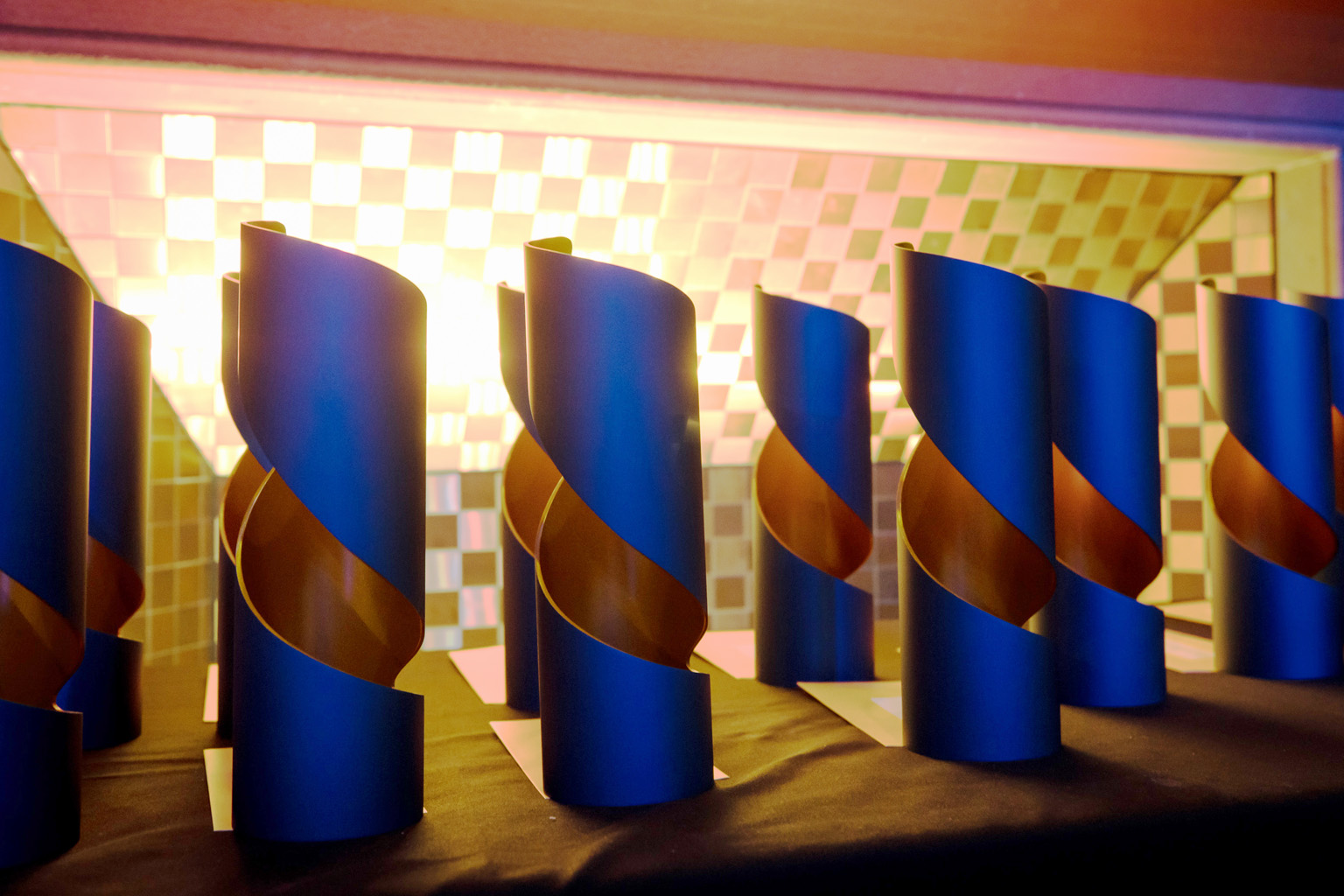 Media awards trophies lined up on a table