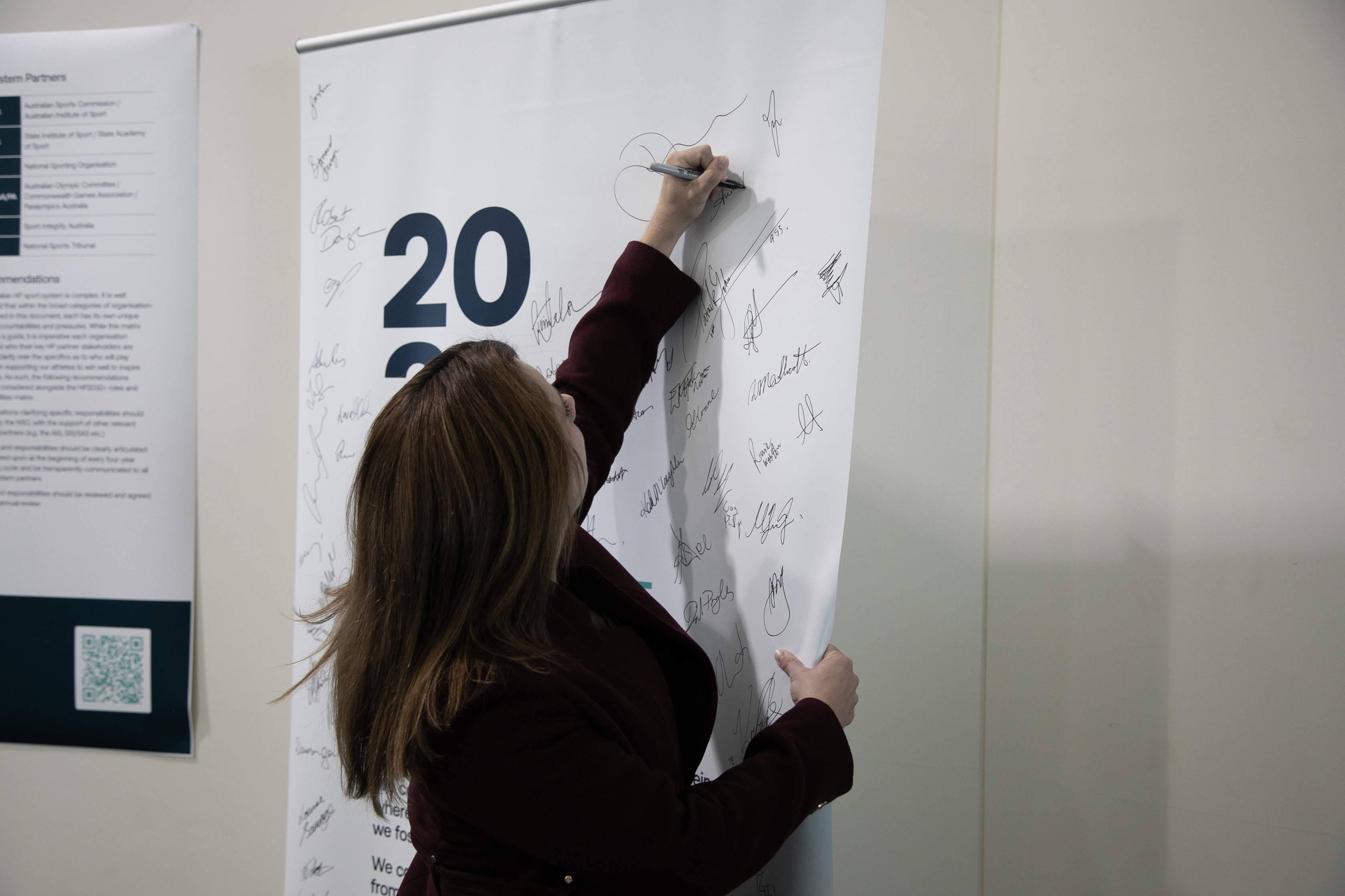 The Minister for Sport, the Hon Anika Wells, signs the Win Well Pledge while at the HP2032+ Strategy Forum at the AIS in Canberra.