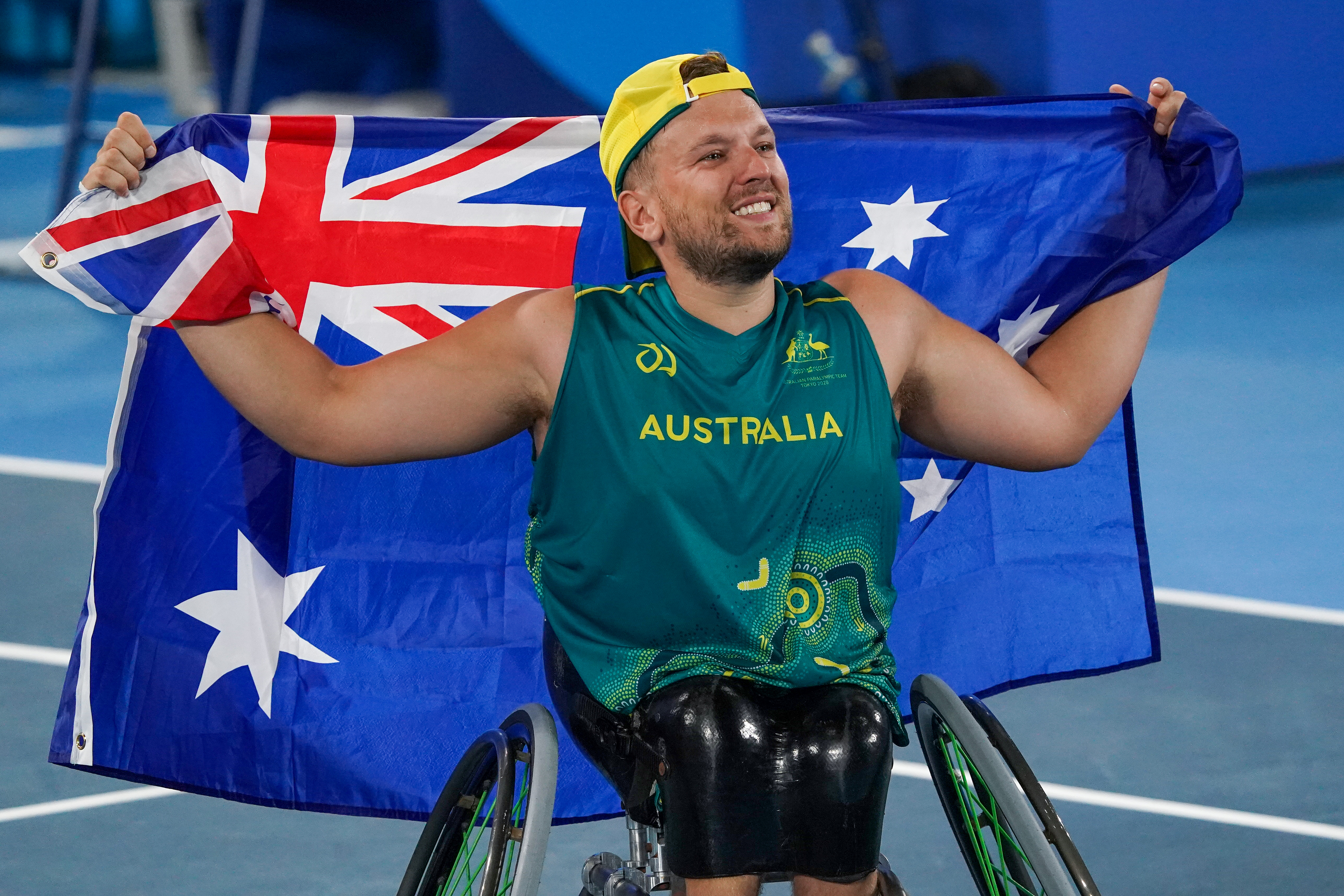 Dylan Alcott holds Australian Flag.