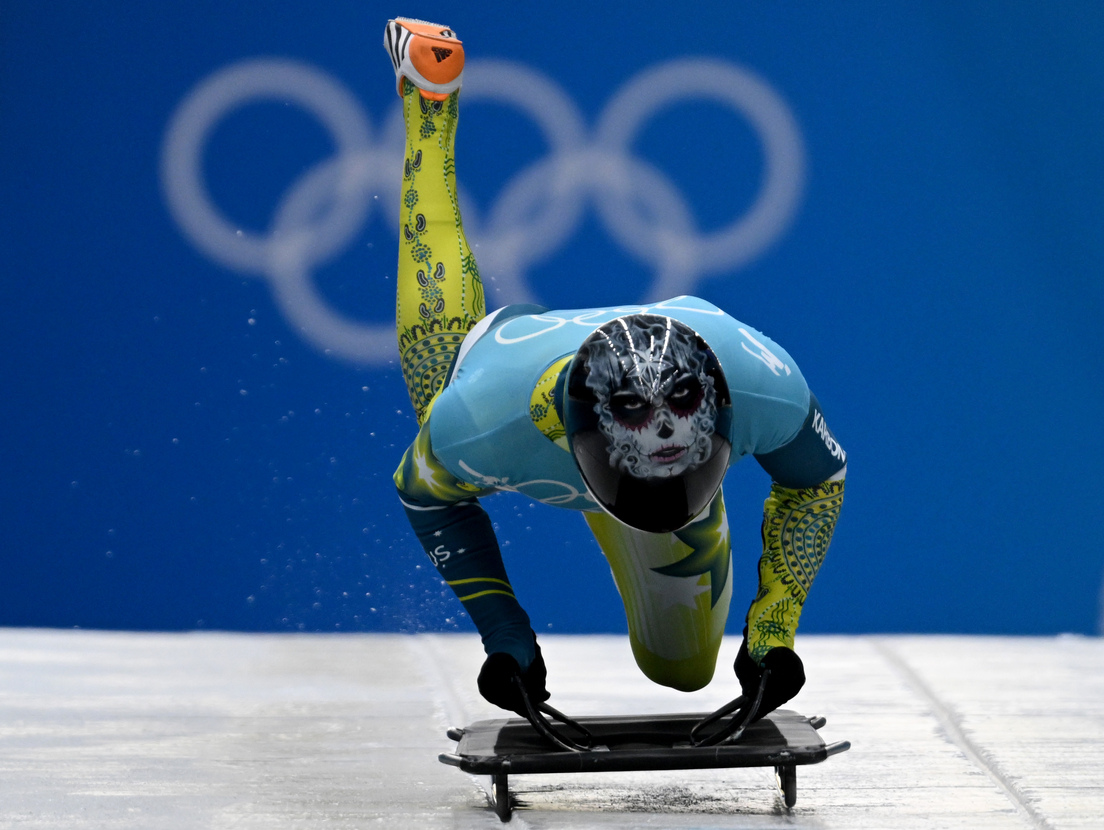 Image of a skeleton racer jumping into a skeleton on ice.